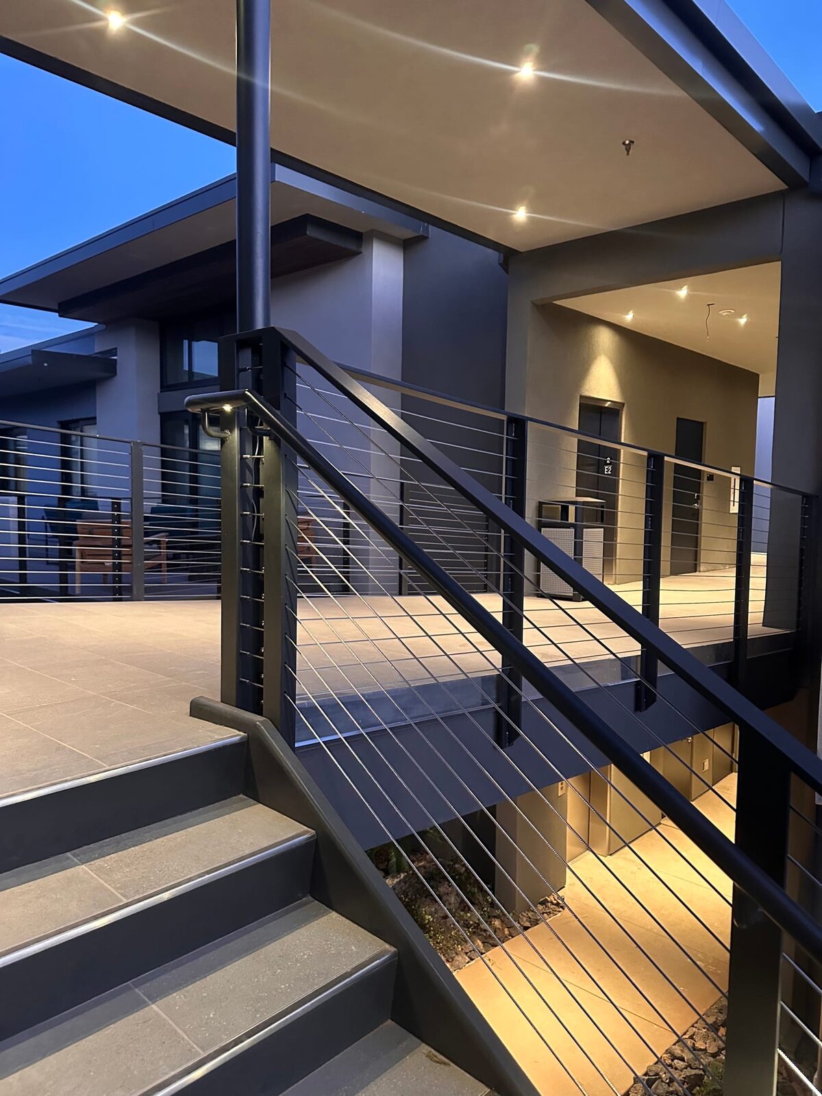 Stainless cable railing and lighted grab rail at Black Desert Resort, on-site fabrication