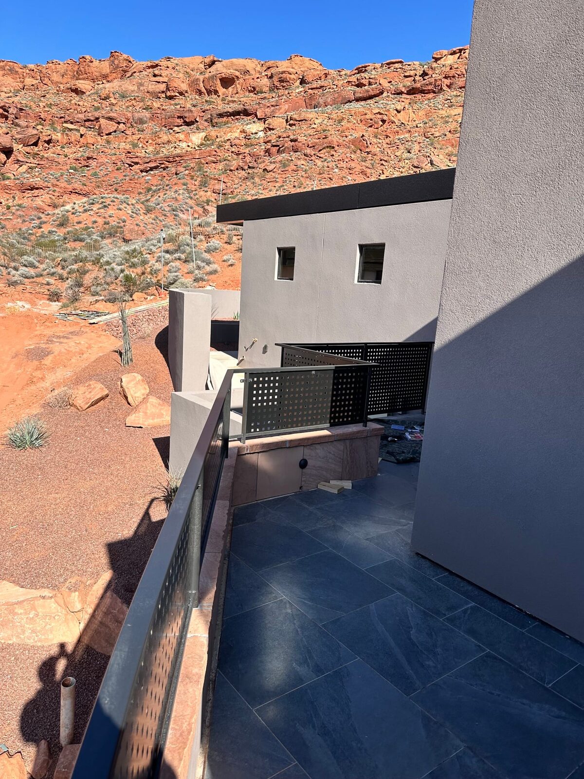 Custom radius steel railing following curved concrete at Entrada at Snow Canyon, close-up