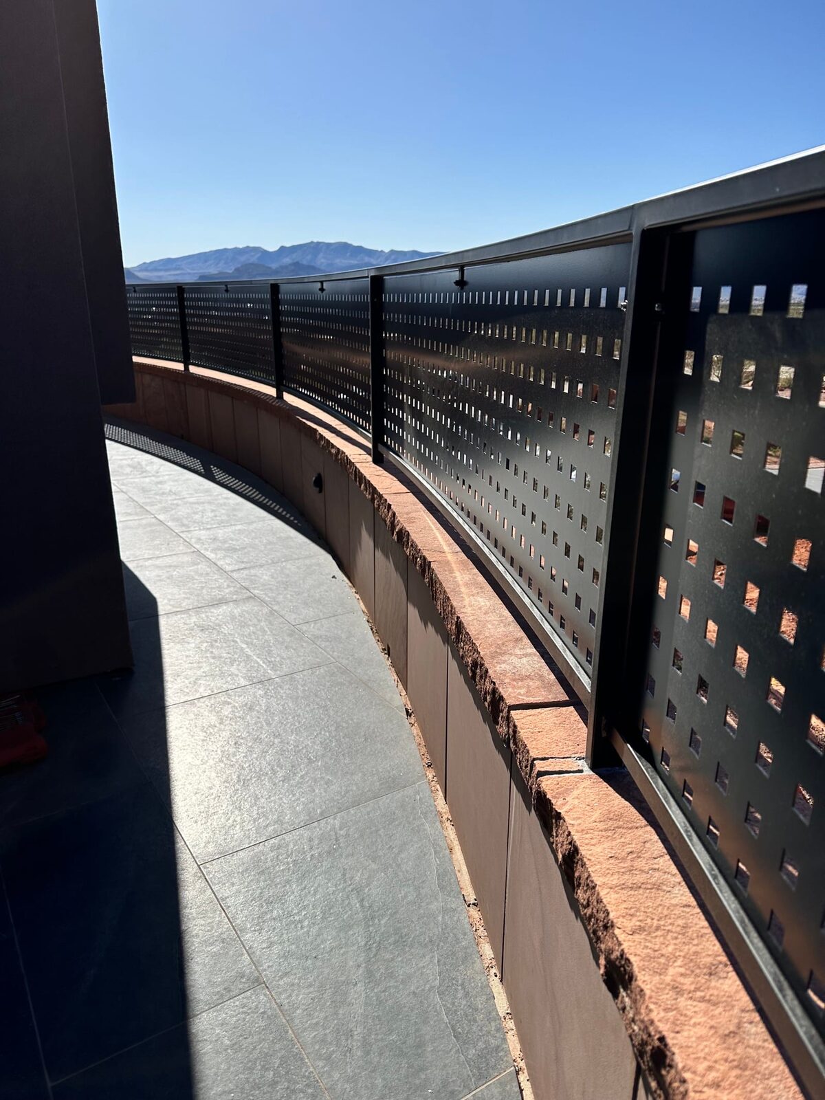 Custom radius steel railing following curved concrete at Entrada at Snow Canyon
