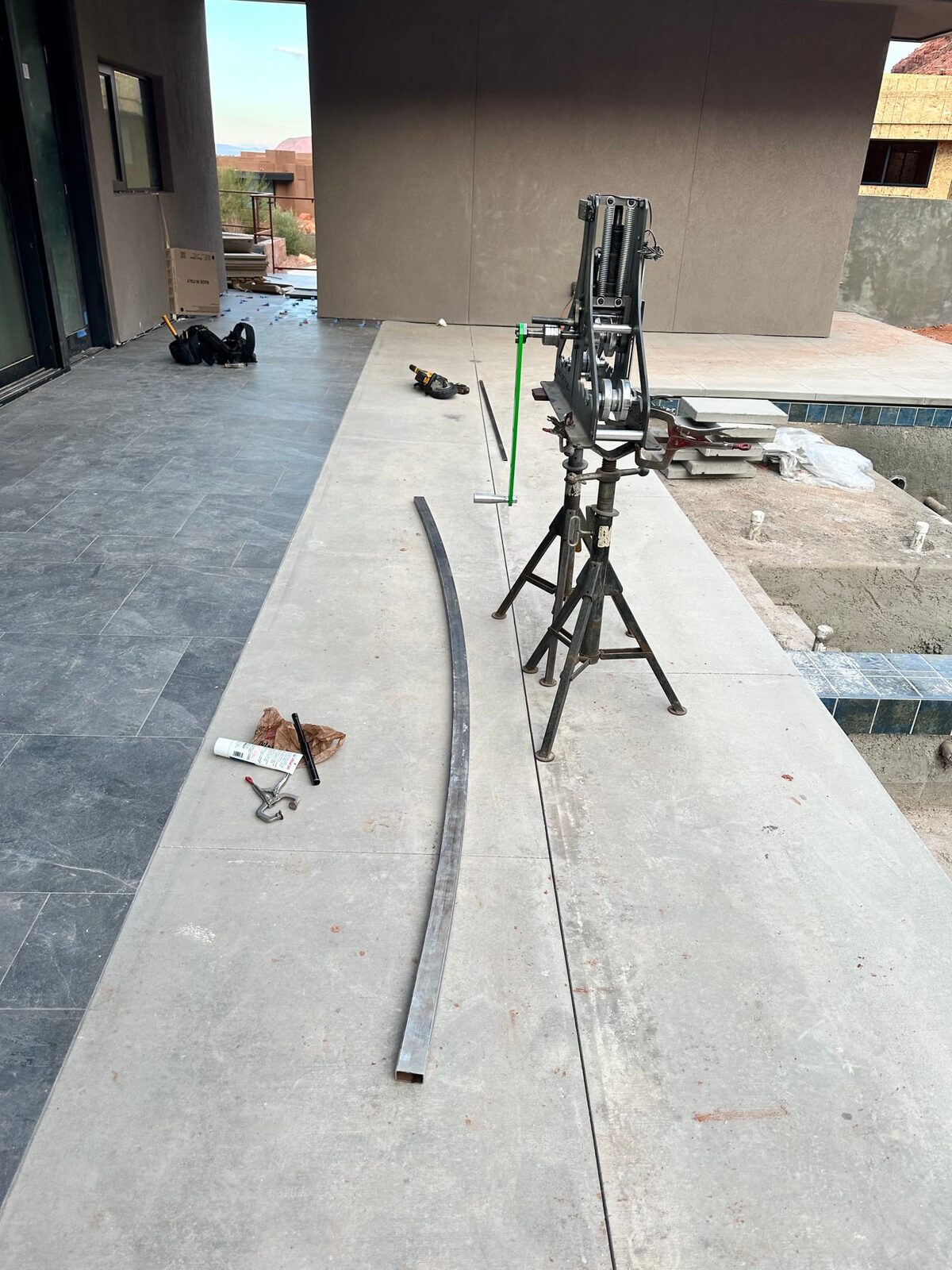 Custom radius steel railing following curved concrete at Entrada at Snow Canyon, close-up