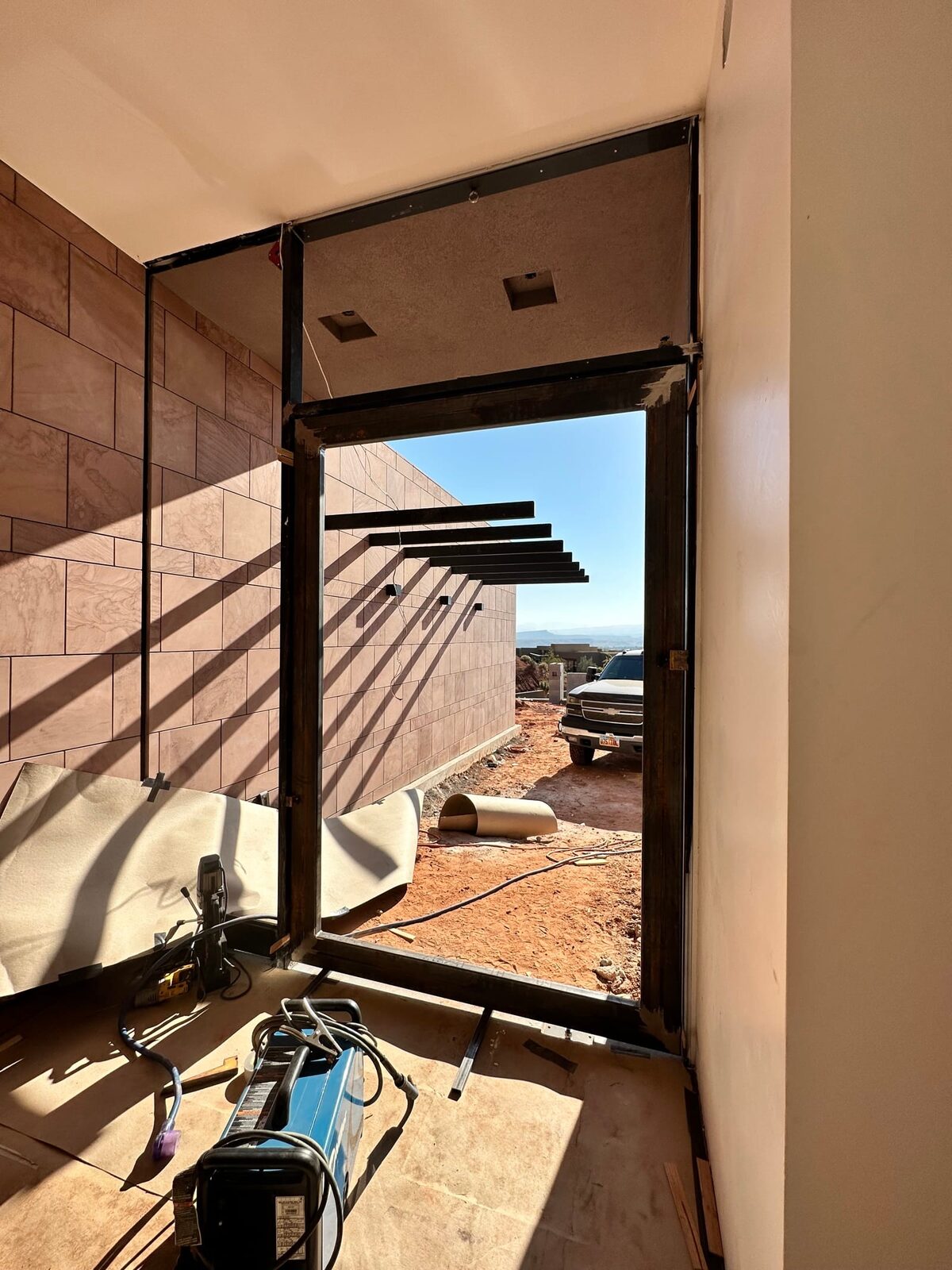 Custom steel grand entry door fabricated for the Entrada residence, on-site fabrication