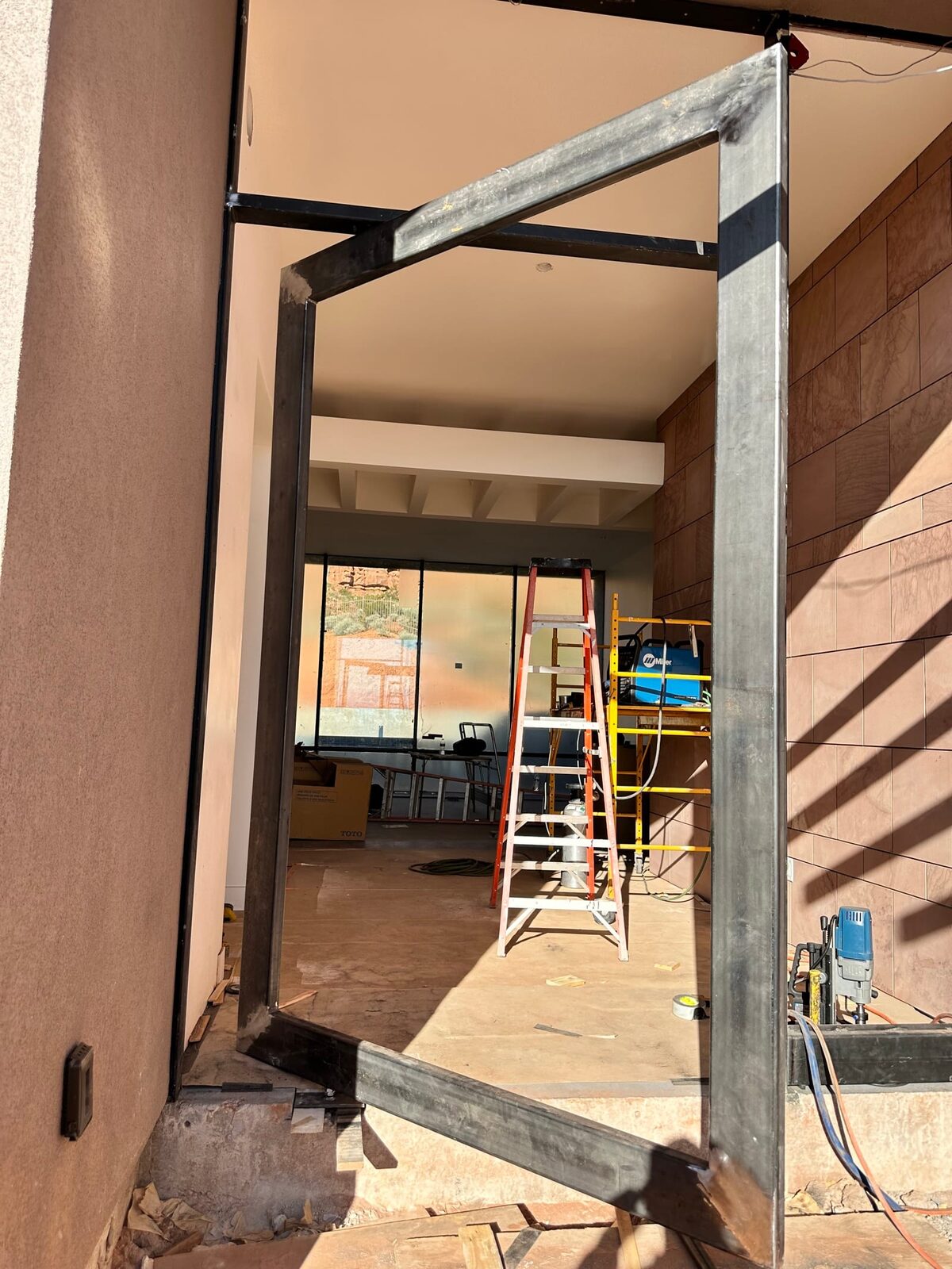 Custom steel grand entry door fabricated for the Entrada residence, finished installation