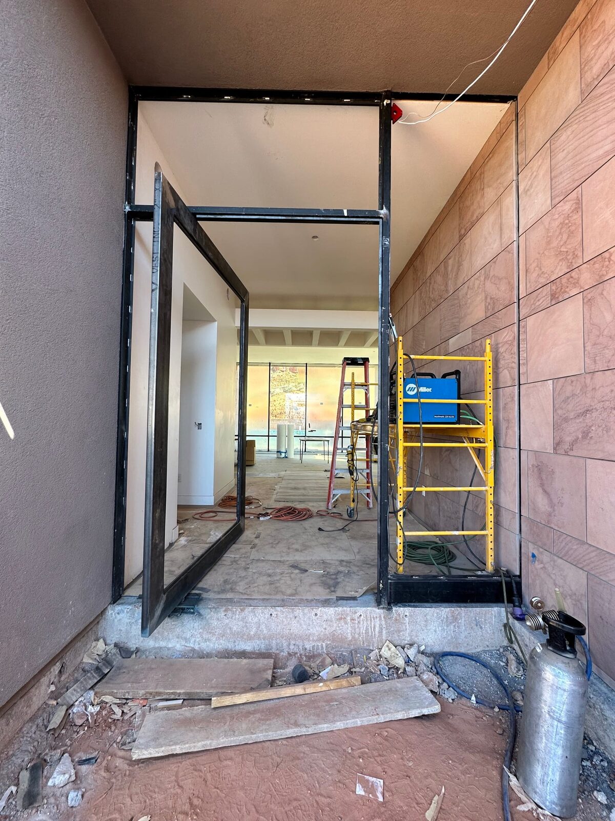 Custom steel grand entry door fabricated for the Entrada residence, on-site fabrication