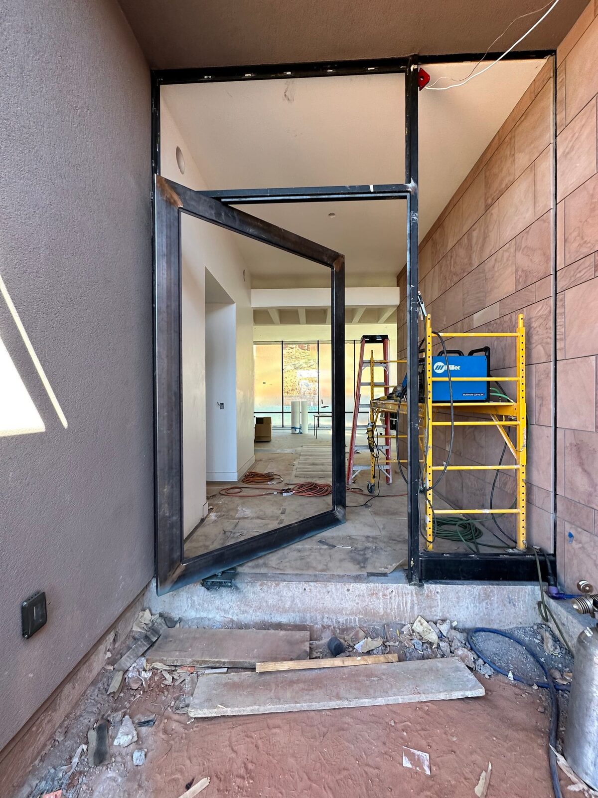 Custom steel grand entry door fabricated for the Entrada residence, finished installation