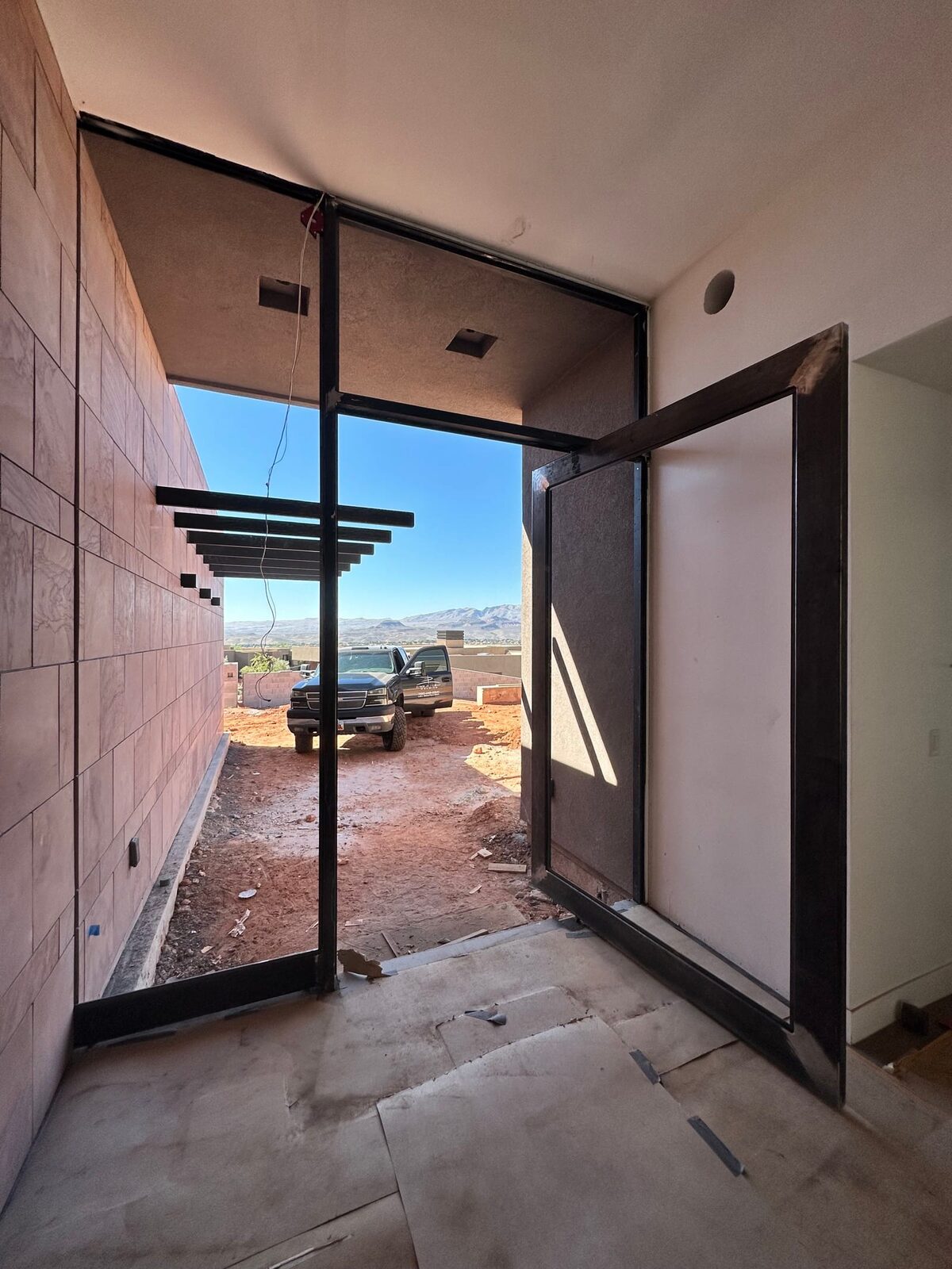 Custom steel grand entry door fabricated for the Entrada residence