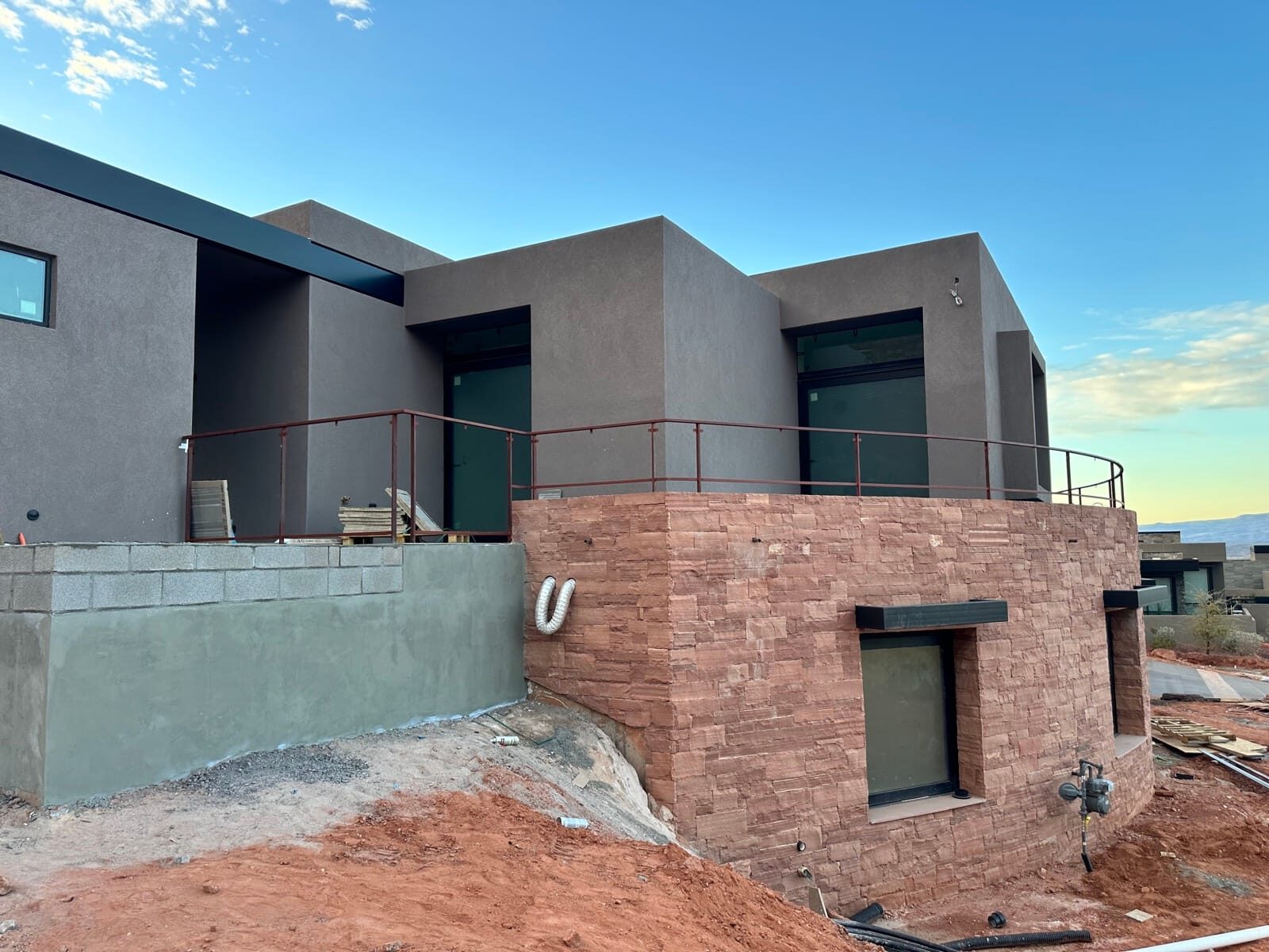 Custom radius steel railing following curved concrete at Entrada at Snow Canyon, finished installation
