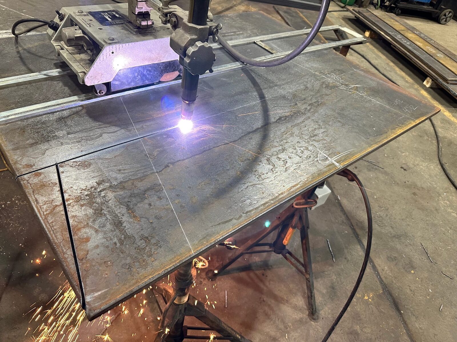Topside fabrication of new heavy-gauge steel mine chutes and shaft supports, close-up