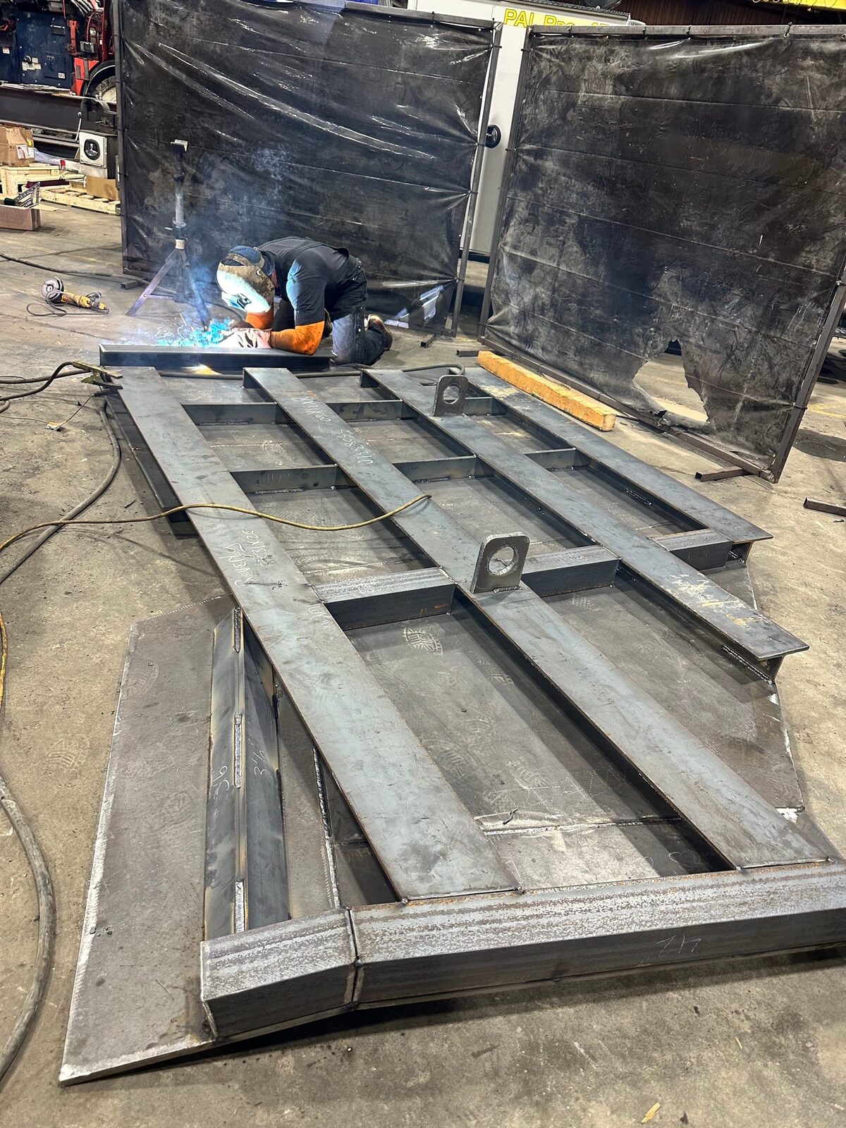 Topside fabrication of new heavy-gauge steel mine chutes and shaft supports, detail