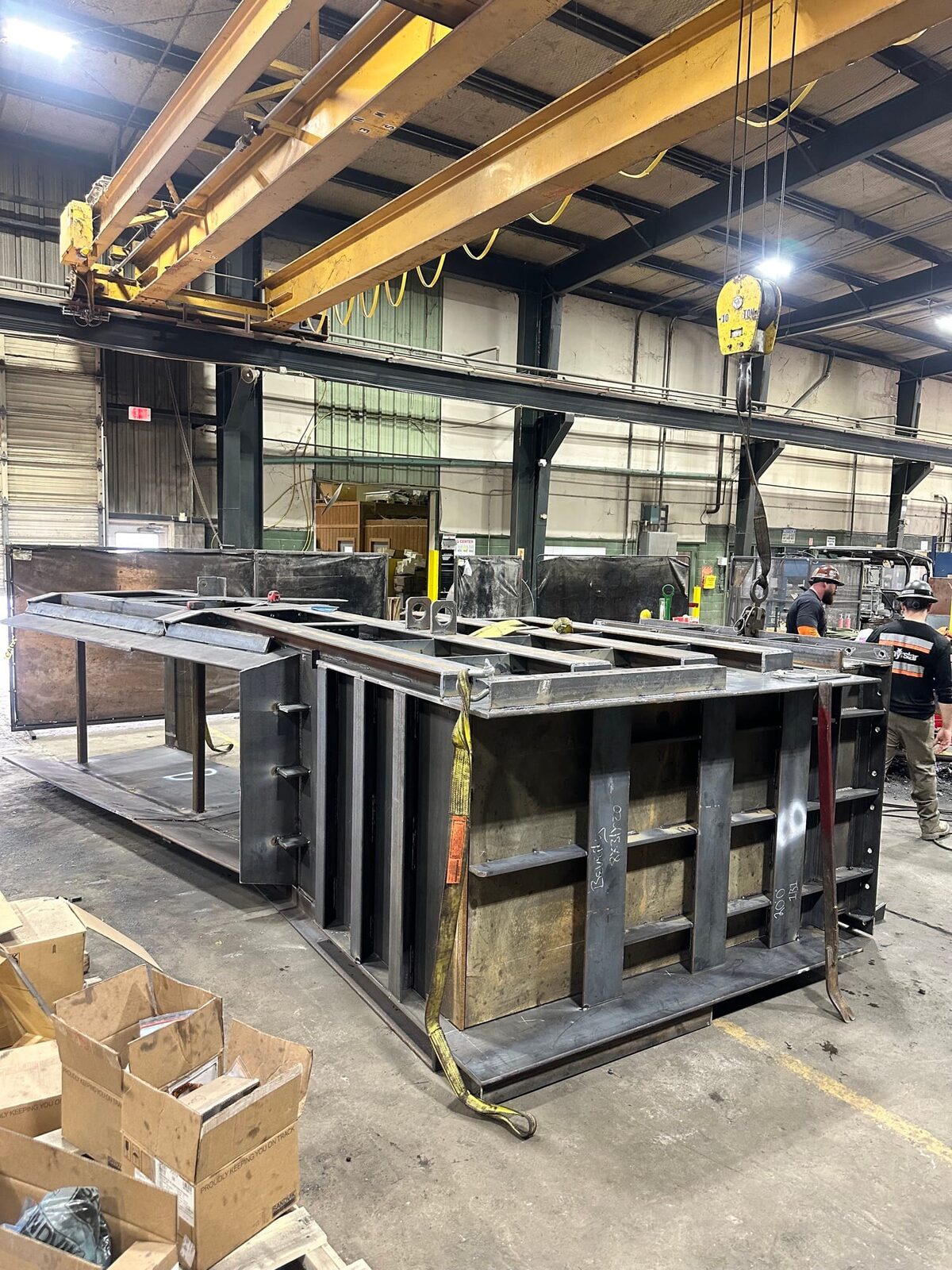 Topside fabrication of new heavy-gauge steel mine chutes and shaft supports, finished installation