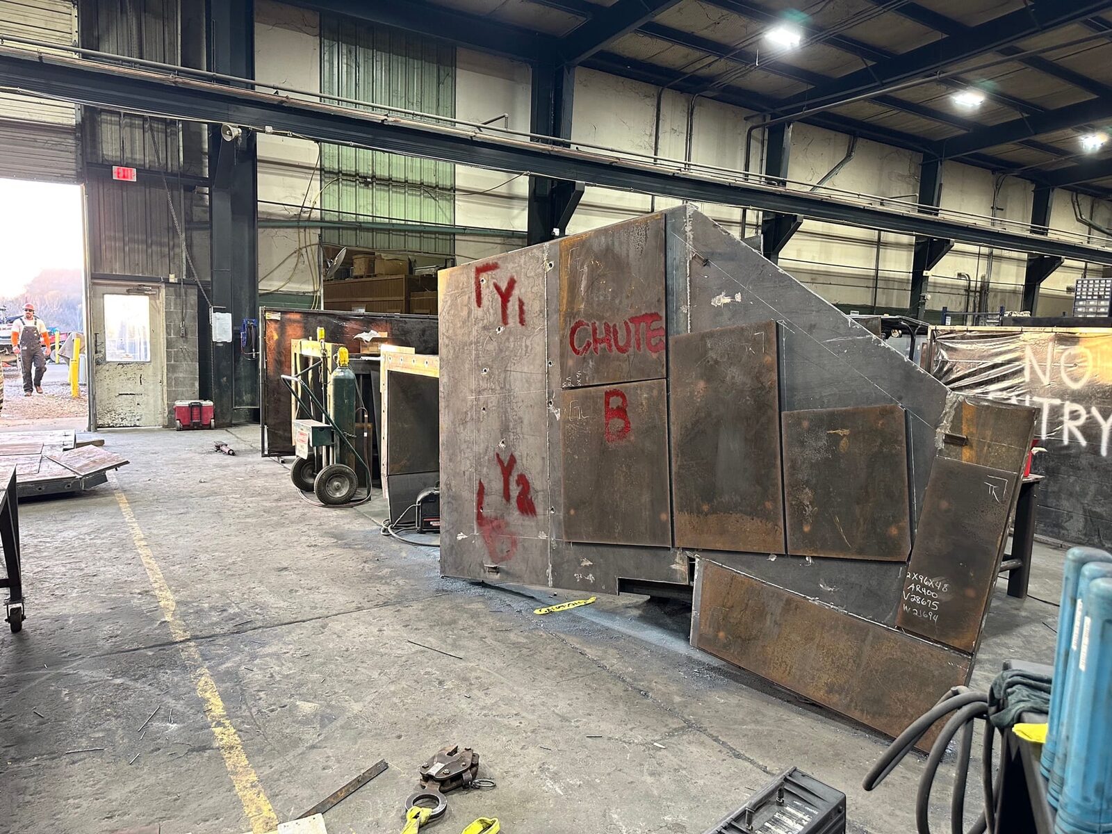 Topside fabrication of new heavy-gauge steel mine chutes and shaft supports, close-up