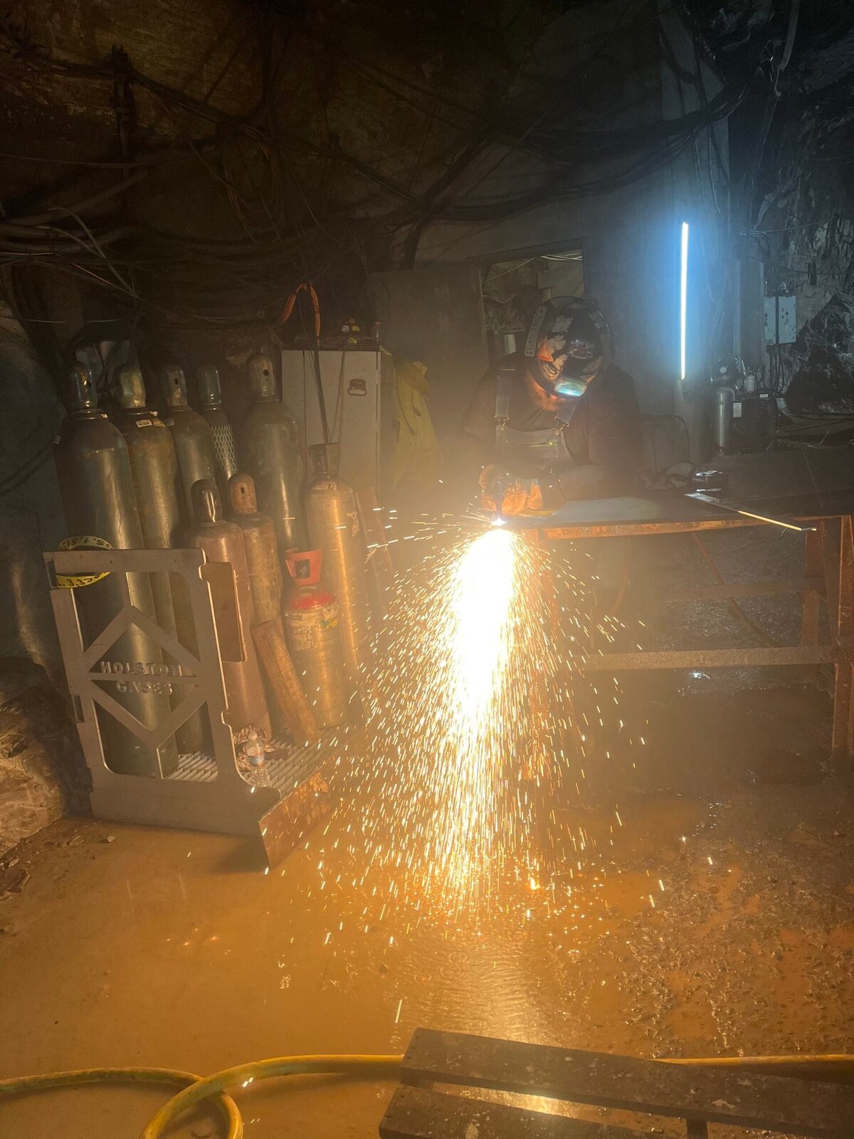 Underground crusher-assembly re-skin with custom-cut AR-500 wear plate, on-site fabrication