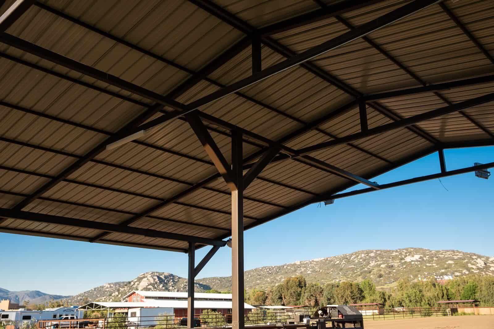 Steel I-beam covered arena and shade pavilion with tube-steel columns, on-site fabrication